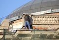 Guest worker on the roof of a renovated house