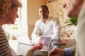 Guests checking in at a hotel using a tablet computer Royalty Free Stock Photo