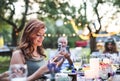 Guests with smartphones taking photo at wedding reception outside. Royalty Free Stock Photo