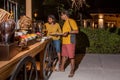 Guests taking food during the international cuisine dinner outdoors setup at the tropical island restaurant