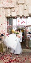 Guests Throwing Confetti Over Bride And Groom At Wedding Royalty Free Stock Photo