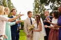 Guests Throwing Confetti Over Bride And Groom At Wedding