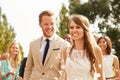 Guests Throwing Confetti Over Bride And Groom At Wedding Royalty Free Stock Photo