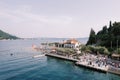 Guests walk along the pier near the sea opposite the hotel. Lepetane, Montenegro. Drone Royalty Free Stock Photo