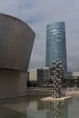 guggenheim museum with the sculpture the big tree and torre iberdrola, bilbao, spain