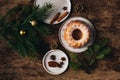 Guglhupf austrian cake with anise and cinnamon in a white plate with wood background. New year and christmas concept Royalty Free Stock Photo