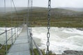 The Guhkesvakkjahka suspension bridge between Sarek and Stora Sjofallet national parks in Sweden. Bridhe over wild