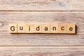 Guidance word written on wood block. Guidance text on table, concept Royalty Free Stock Photo