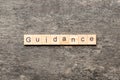 Guidance word written on wood block. Guidance text on table, concept Royalty Free Stock Photo