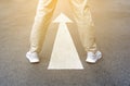 Guide of feet arrow on road background. Man in casual shoes standing on asphalt. Concept of new start, choice business, way to Royalty Free Stock Photo