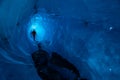 Guide inside an ice cave on a glacier in Alaska. Glacier caves are rare on teh Matanuska, but this one runs deep into the ice Royalty Free Stock Photo