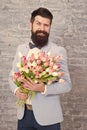 Guide for modern man. Romantic man with flowers. Romantic gift. Macho getting ready romantic date. Tulips for sweetheart Royalty Free Stock Photo