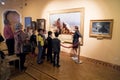 The guide tells a group of people about the painting The Merciful Samaritan 1874 of the great Russian artist V. Surikov 1848Ã¢â¬â