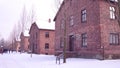 Guided tour to Auschwitz Birkenau, German Nazi concentration and extermination camp. Brick buildings in the snow Royalty Free Stock Photo