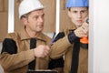 Guiding apprentice in drilling wall Royalty Free Stock Photo