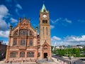 The Guildhall in Derry ~ Londonderry with the Peace Bridge in the right background. Taken on a sunny day with blue sky and white