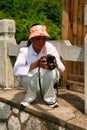 Guilin, China - July 16, 2018: A Chinese female photographer doing photos during descending from Yaoshan Mountain.