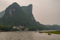 Boat traffic around bend on Li River in Guilin, China