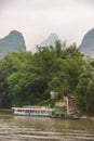 Ferry and transport boat docked at stairs along Li River in Guilin, China Royalty Free Stock Photo