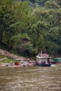 Woman leaves raft and ferry docked at stairs along Li River in Guilin, China Royalty Free Stock Photo