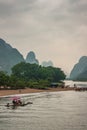 Small raft ferries traveling along shore of Li River in Guilin, China