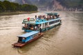 Small vendor boat approaches tourist vessel on Li River in Guilin, China