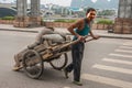 Man pulls cart with bags, Guilin, China