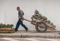 Man pulls cart full of bags, Guilin, China