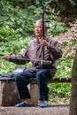 Man plays the erhu or Chinese violin at Seven Star Park, Guilin, China