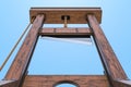 Guillotine, bottom view against blue sky. 3D rendering