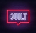Guilt neon sign on brick wall background.