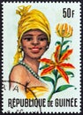 GUINEA - CIRCA 1966: A stamp printed in Guinea shows Ammocharis and Woman