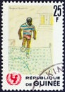 GUINEA - CIRCA 1966: A stamp printed in Guinea shows footballer children drawing, circa 1966.