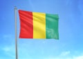 Guinea flag waving sky background 3D illustration Royalty Free Stock Photo