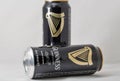 Guiness draught beer cans closeup against white