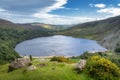 Guiness Lake with moored Viking longships and wooden village in Wicklow Mountains