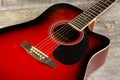 Guitar acoustic red, neck lying on a vintage background of wood on the background of old grunge boards. View Royalty Free Stock Photo