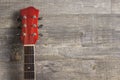 Guitar acoustic red, neck lying on a vintage background of wood on the background of old grunge boards. Place for text Royalty Free Stock Photo