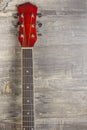 Guitar acoustic red, neck lying on a vintage background of wood on the background of old grunge boards. Place for text Royalty Free Stock Photo