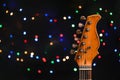 Guitar against blurred lights. Christmas music