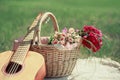 Guitar, basket and bouquet of flowers. Vintage tender background