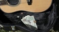 Guitar case with money busker Royalty Free Stock Photo
