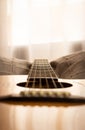 Guitar close-up view. Overexposed background. Selective focus