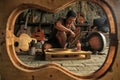 A guitar craftsman is busy making orders from his clients.