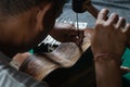 A guitar craftsman are carving a classical guitars made from wood, with Balinese pattern, in a wooden guitar workshop at Guwang