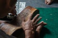 A guitar craftsman are carving a classical guitars made from wood, with Balinese pattern, in a wooden guitar workshop at Guwang