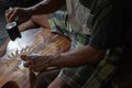 A guitar craftsman are carving a classical guitars made from wood, with Balinese pattern, in a wooden guitar workshop owned by I