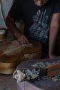 A guitar craftsman are carving a classical guitars made from wood, with Balinese pattern, in a wooden guitar workshop at Guwang