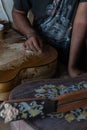 A guitar craftsman are carving a classical guitars made from wood, with Balinese pattern, in a wooden guitar workshop at Guwang