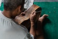 A guitar craftsman are carving a classical guitars made from wood, with Balinese pattern, in a wooden guitar workshop at Guwang